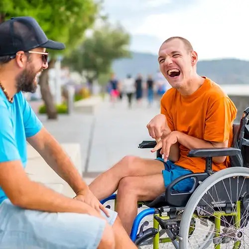 Person with disability laughing on river front